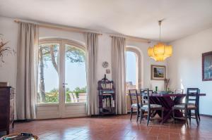 a dining room with a table and a large window at Il Grifo - Cozy house, wonderful view in Portoferraio