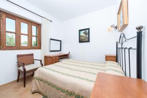 a bedroom with a bed and a chair and a desk at Son March in Petra +30 photos