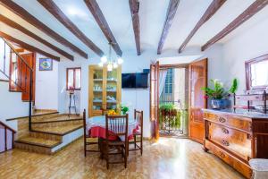 a kitchen and dining room with a table and chairs at Can Murons in Fornalutx