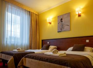 Postel nebo postele na pokoji v ubytování Hotel Piotr Spa&Wellness