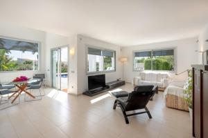 a living room with a couch and a table at Villa Xipell 9 in Cala Santandria