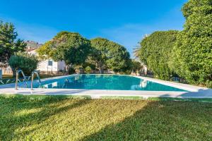 a swimming pool in a yard with trees at Rosmare in Port d'Alcudia