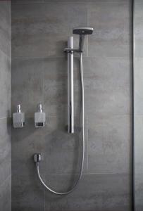 a shower with a shower head in a bathroom at The Hamptons in Kaikoura