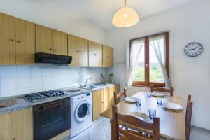 a kitchen with a table and a stove top oven at Casa Lucia Marina di Campo in Campo nell'Elba
