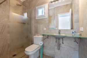 a bathroom with a toilet and a sink and a mirror at Bungalow Cala Dor 27 in Cala d´Or +17 photos