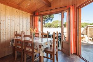 a wooden dining room with a table and chairs at Las tres hermanas in Conil de la Frontera