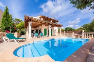 a villa with a swimming pool and a gazebo at Can Mateu in Cala Santanyi