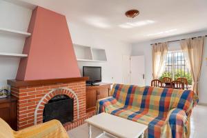 a living room with a couch and a fireplace at Casa - 4 Mar y Arena in Barbate