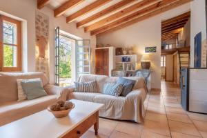 a living room with a couch and a table at Finca Ca'n Vaqueta in Sóller