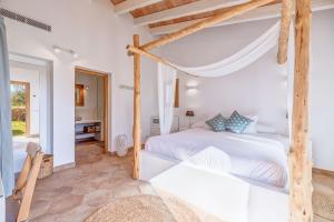 a bedroom with a large bed and a desk at Sa Vinya Jove in Biniali