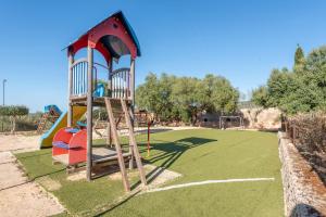 a playground with a slide in a park at Es Rafal Roig - Es Galiner in Sant Llorenç des Cardassar