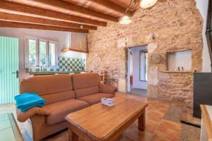 a living room with a couch and a table at Es Rafal Roig - Es Cestador in Sant Llorenç des Cardassar