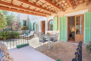 a patio with a table and chairs on a house at Es Rafal Roig - Es Verd in Sant Llorenç des Cardassar