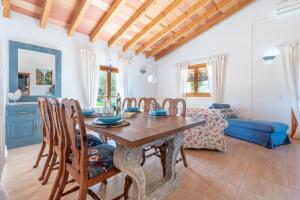 a kitchen and dining room with a wooden table and chairs at Casa Yolanda in Sant Llorenç des Cardassar