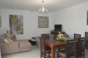 a living room with a table and a couch at Villa Ana in Alhaurín el Grande