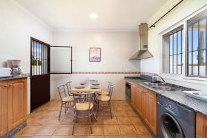 a kitchen with a table and chairs in it at Chalet Isla del Sotillo in Chiclana de la Frontera