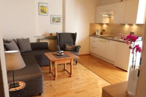 a living room with a couch and a table at Haus Pöckl in Strobl