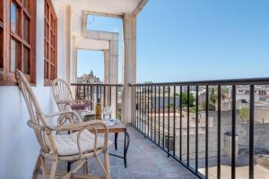 a balcony with chairs and a table and a view at Bennassar 2 in Felanitx