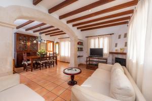 a living room with a white couch and a table at Dofí in Cala Millor