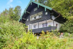 a black and white house with a green roof at Ferienhaus Mei Ruah in Ruhpolding