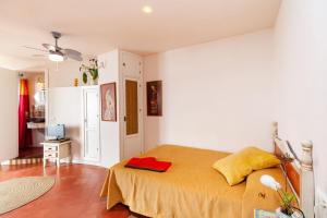 a bedroom with a large bed with a yellow blanket at Gloria 3 in Conil de la Frontera