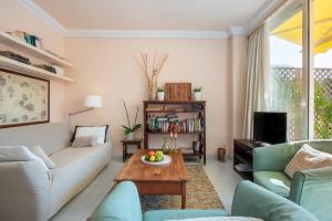 a living room with a couch and a table at Apartament Carla in Port de Soller