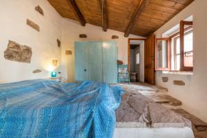 En eller flere senge i et værelse på Dimora tipica Carlofortina