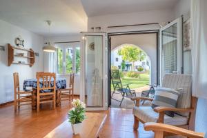 a living room with a door open to a patio at La Gardenia 41 in Es Castell