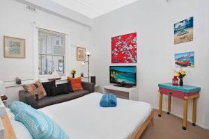 a living room with two beds and a couch at Marine Parade in Sydney