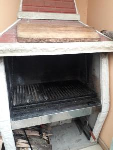a stove top oven sitting in a room at LA CASA DEL MONO in Ushuaia