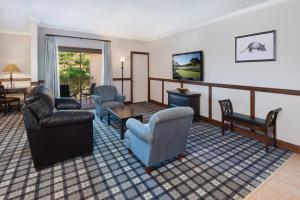 a living room with couches chairs and a tv at Tapatio Springs Hill Country Resort in Boerne