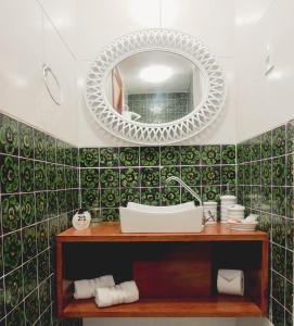 a bathroom with a sink and a mirror at Casa Perpetua Hotel D Charm in Manaus