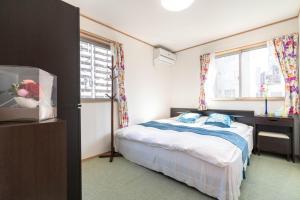 Postel nebo postele na pokoji v ubytování Travel Palace Miyuki