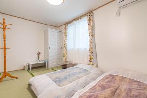 Postel nebo postele na pokoji v ubytování Travel Palace Miyuki