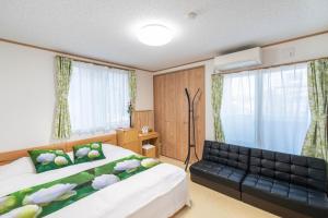 Postel nebo postele na pokoji v ubytování Travel Palace Miyuki