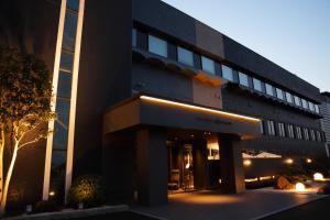 a black building with a sign in front of it at THE CHELSEA BREATH in Takamatsu