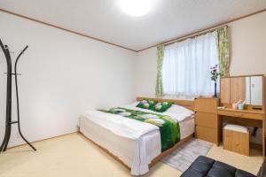 Postel nebo postele na pokoji v ubytování Travel Palace Miyuki