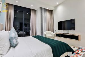 a hotel room with a bed and a television at Expressionz Suites by V&C in Kuala Lumpur