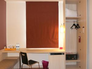 a room with a desk and a chair in a room at Ibis Phuket Kata in Kata Beach