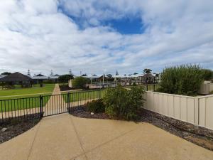 a fence and walkway in a neighborhood with houses at Seafront Unit 25 in Jurien Bay