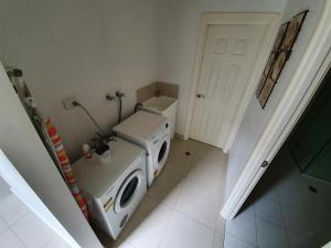 a washing machine in a room with a door at Seafront Unit 25 in Jurien Bay