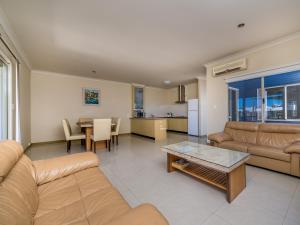 a living room with a couch and a table at Seafront Unit 49 in Jurien Bay