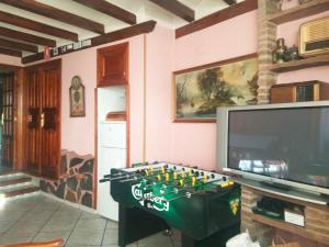 a living room with a foosball table and a tv at Apartamento Turistico Luar 1 in El Rasillo