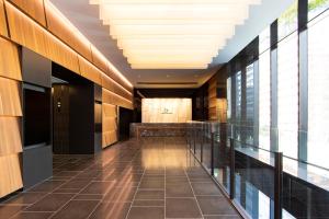 an empty hallway in a building with a large ceiling at karaksa hotel grande Shin-Osaka Tower in Osaka