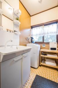 a small kitchen with a sink and a refrigerator at Classic Japan Living ASAMA in Fujikawaguchiko