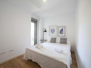 biała sypialnia z dużym białym łóżkiem w pokoju w obiekcie Apartamentos Kasa25 Castaños w Alicante