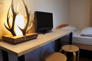 a desk with a computer monitor and antlers on it at SappoLodge in Sapporo