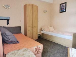 a small bedroom with two beds and a cabinet at Elisabeth Stube in Neuss