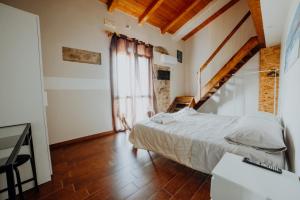 a bedroom with a large bed and a window at Stone house in Novi Velia