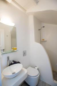 un bagno bianco con lavandino e WC di Madres Houses a Mykonos Città Altre 29 foto